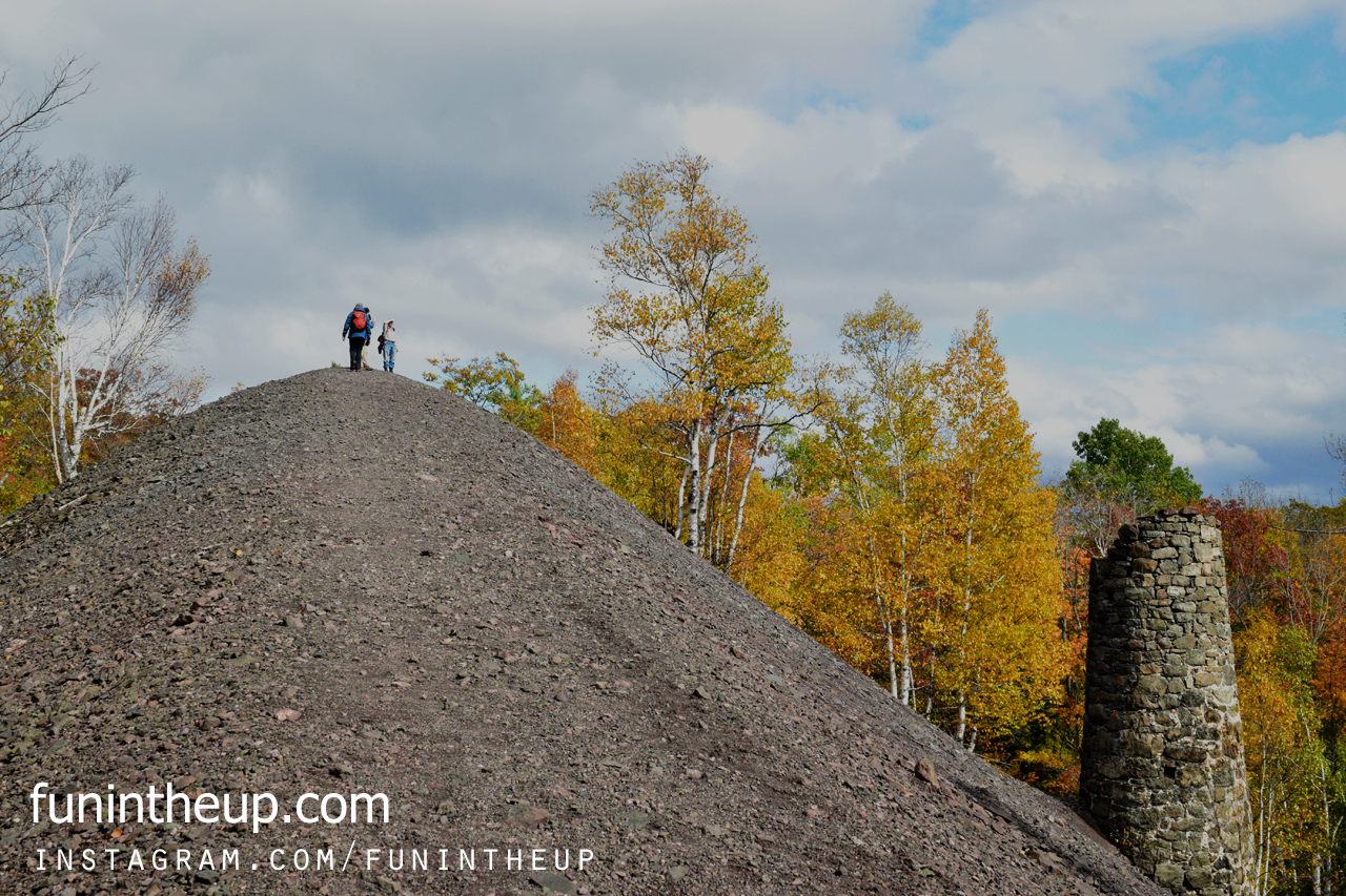 Basalt rock tailings from Cliff mine and smokestack from Hoist house.